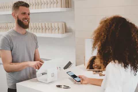 Customer scanning a QR code on a product display in a modern retail store